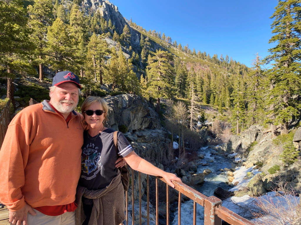 Madi's (author) parents on a bridge in front of a stream during a hike near Lake Tahoe. 