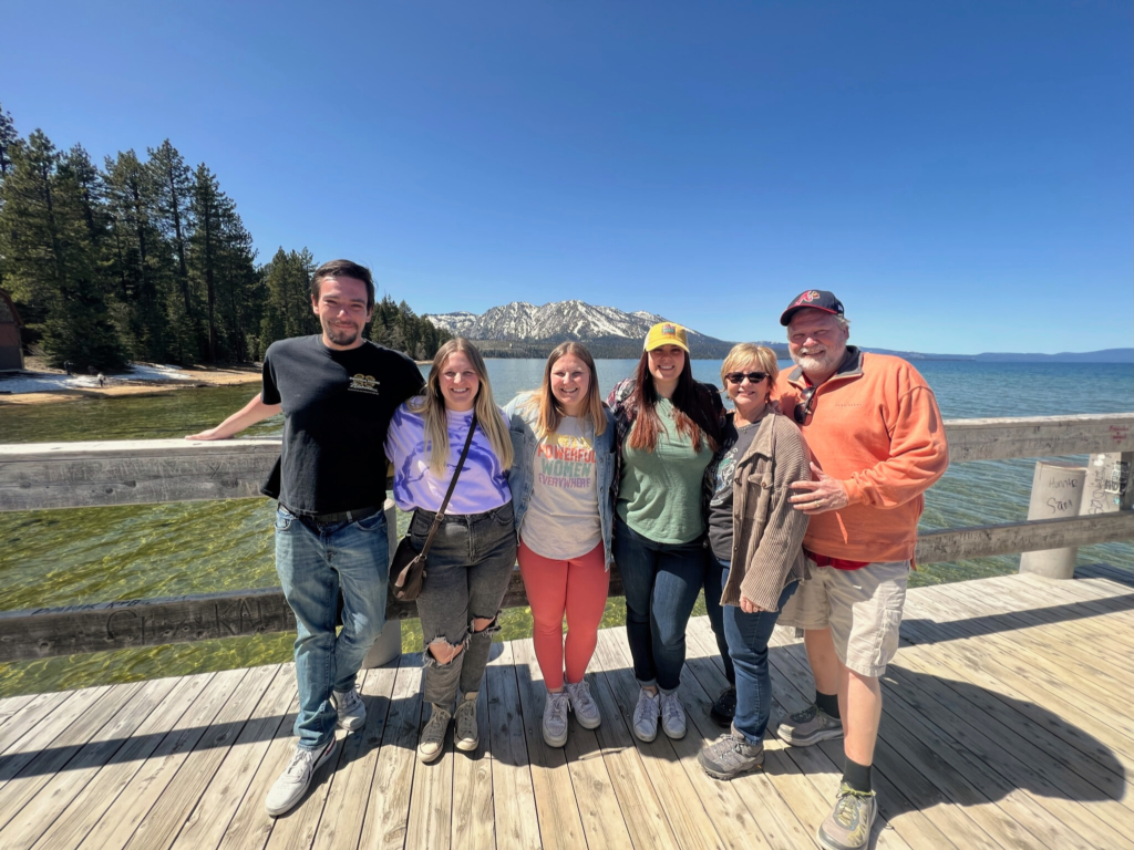 Madi (author) and her family standing on a dock on Lake Tahoe in April.