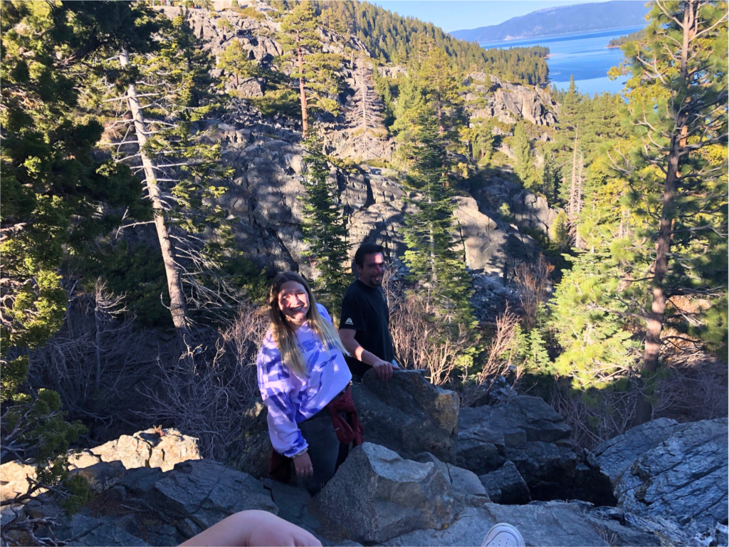 Madi and her cousin on a mountain ledge with Lake Tahoe in the background. 