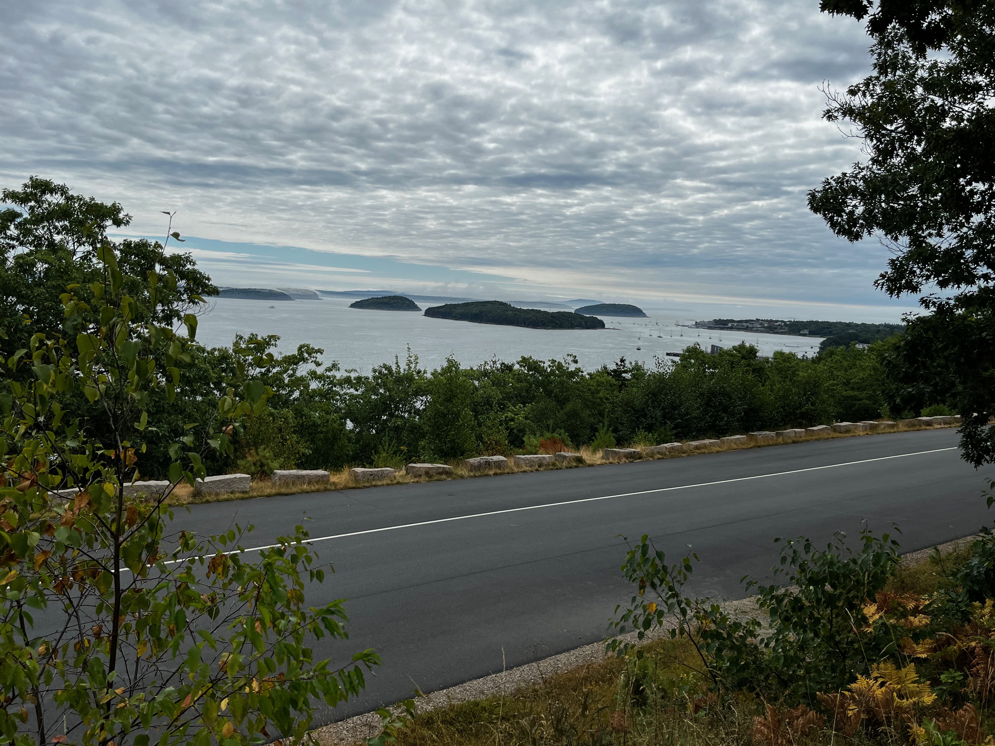 Views of Acadia National Park from the Park Loop road. There are many little islands off the coast of Mount Desert Island with Park Loop Road in the foreground. 