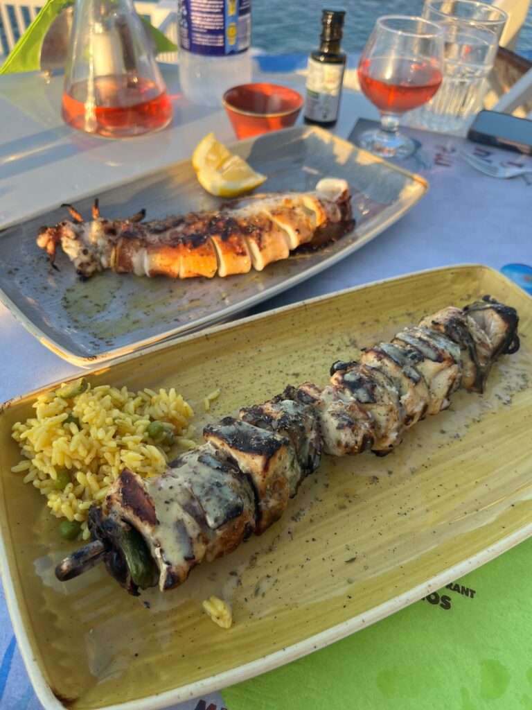 Delicious spread of Swordfish Souvlaki and succulent Octopus dishes from Medusa Restaurant in Mandrakia, Milos, Greece – a culinary delight showcasing the fresh flavors of the Mediterranean seafood cuisine