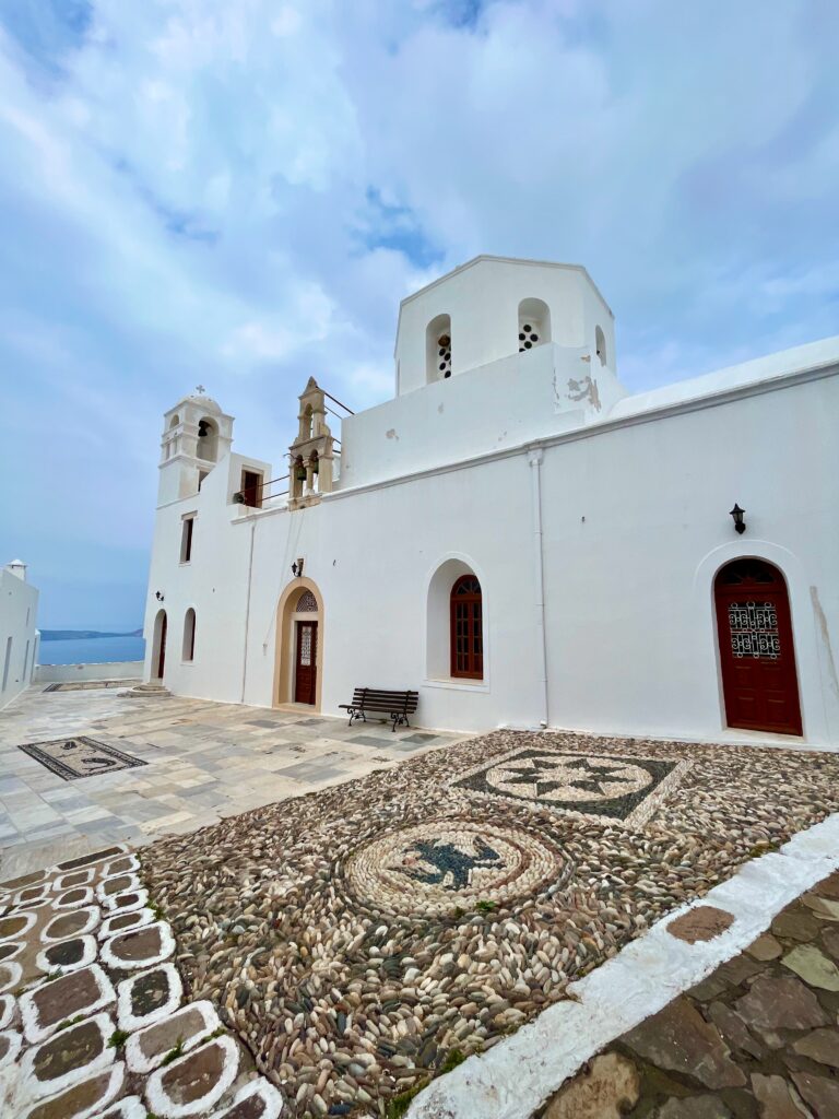 Breathtaking view of the Plaka Castle in Milos, Greece, showcasing ancient stone walls, historic architecture, and the scenic beauty of the surrounding landscape.