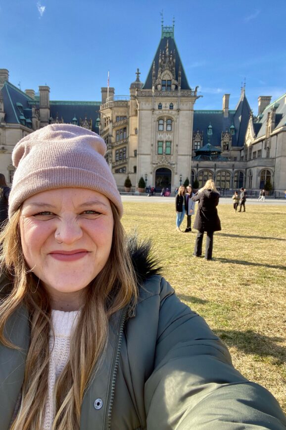 Madi in front of the Biltmore Estate, a must see on your Asheville Bachelorette Party.